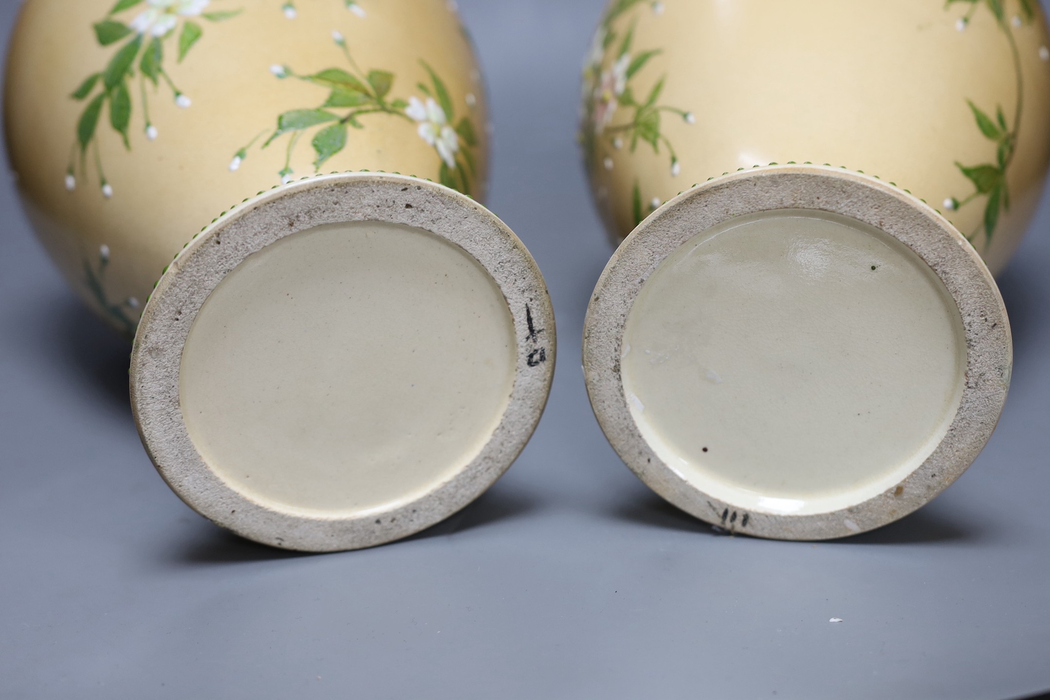 A pair of Japanese Satsuma style cream ground moriage vases, 40cm